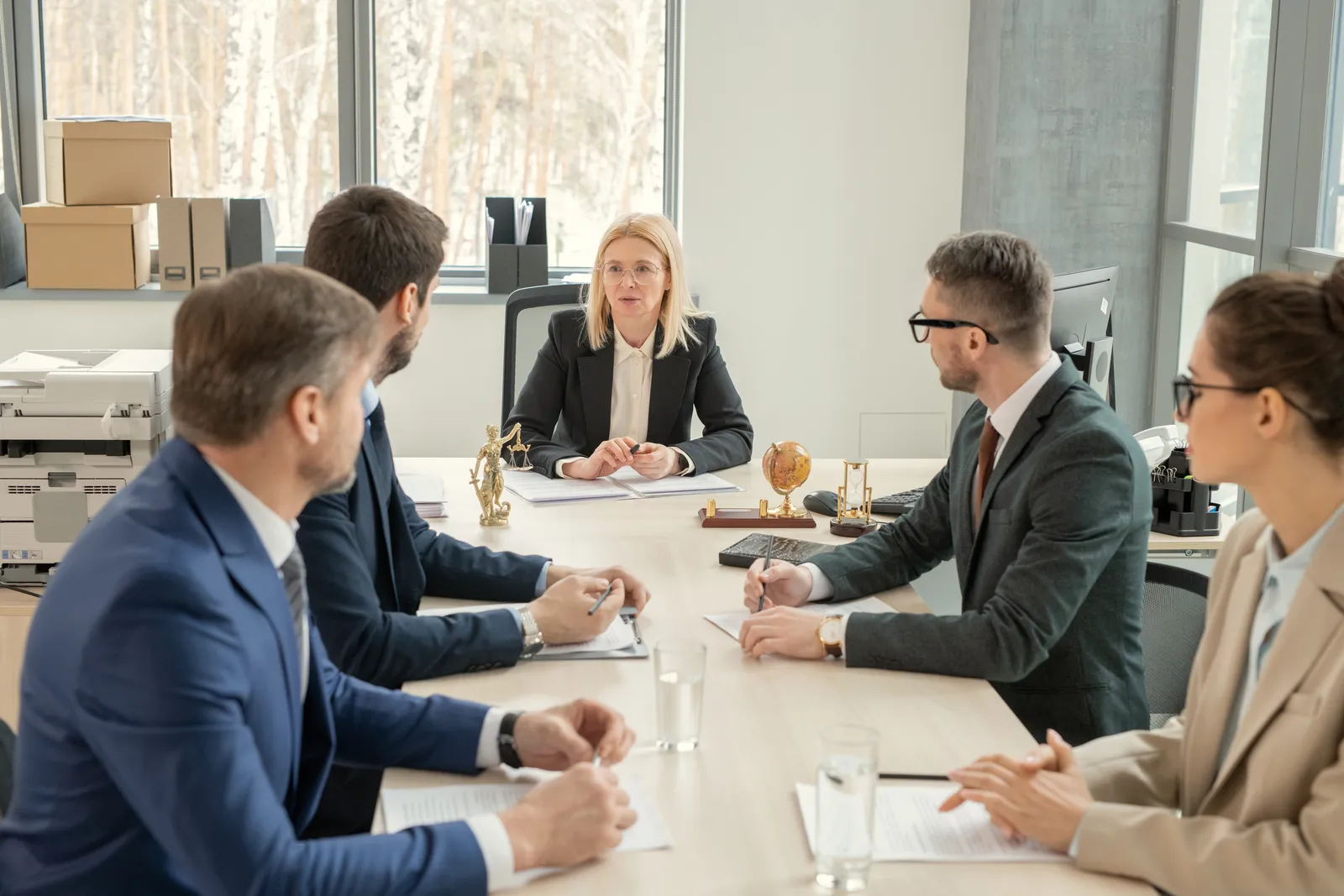 Personal injury attorneys meeting around a conference table to decide case strategy