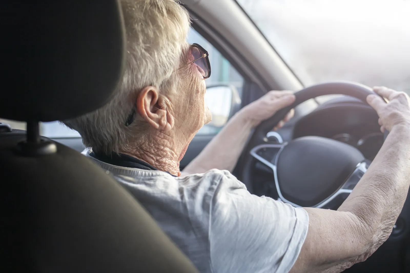 Older woman driving a car, illustrating how the thin skull rule applies to more vulnerable clients