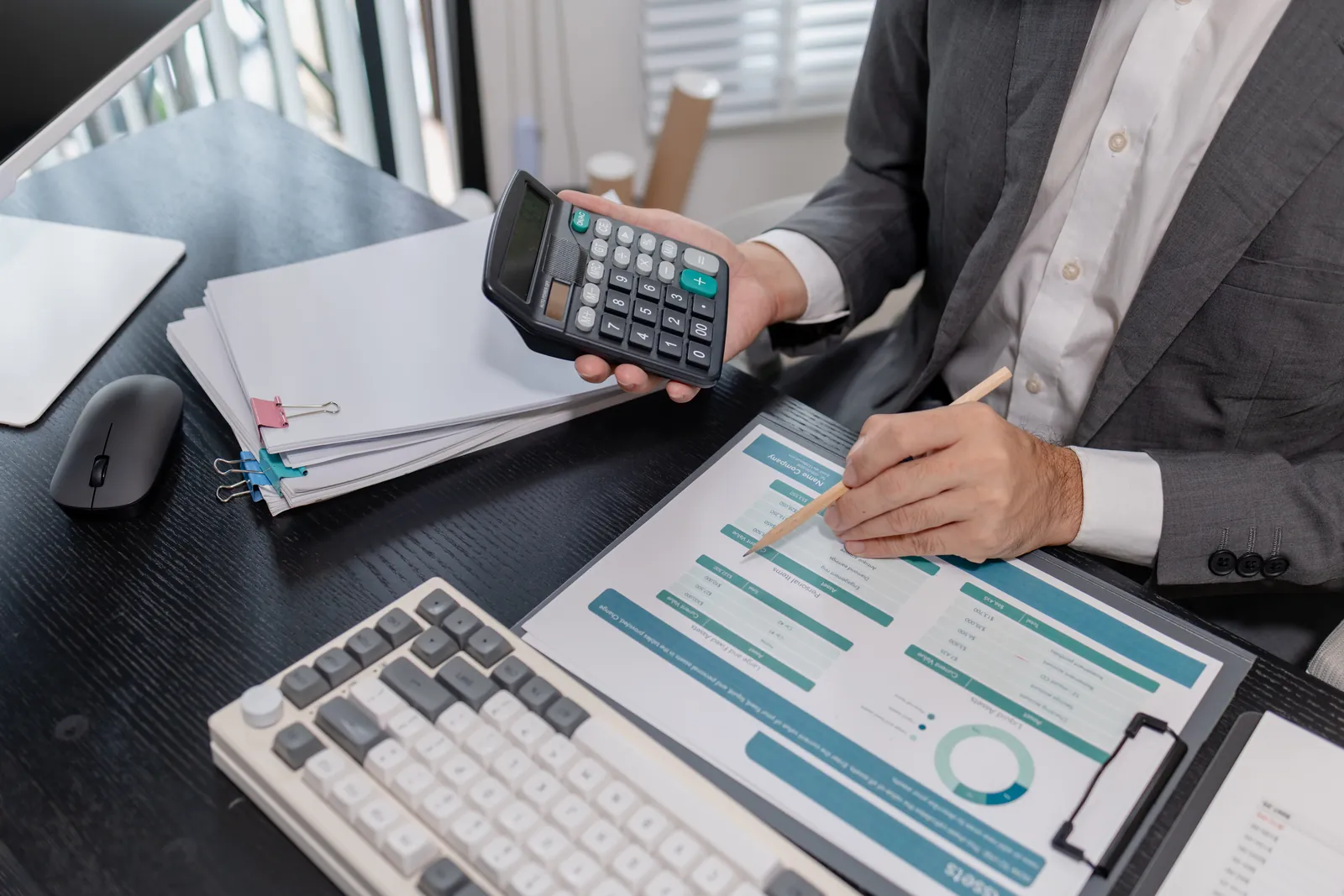 Professional checking medical bills with a calculator, comparing medical record review cost options for a law firm